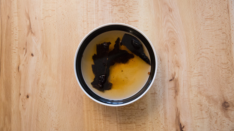 ancho chiles soaking in bowl