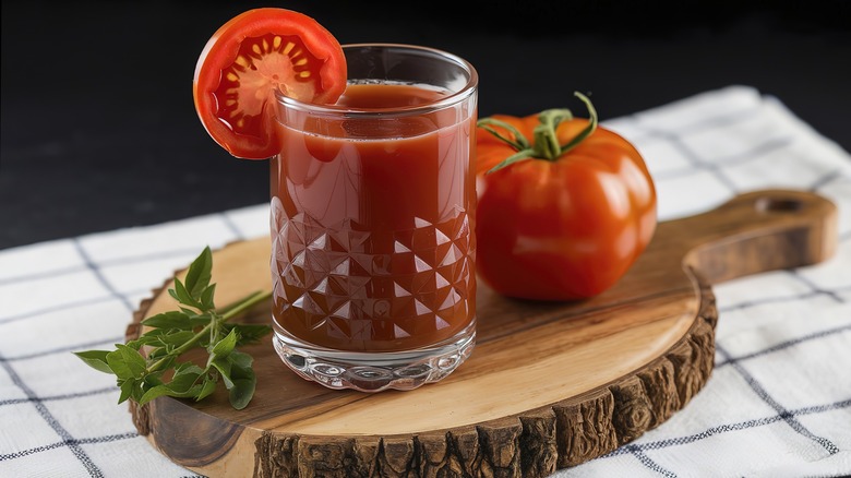 Glass of tomato juice and fresh tomato