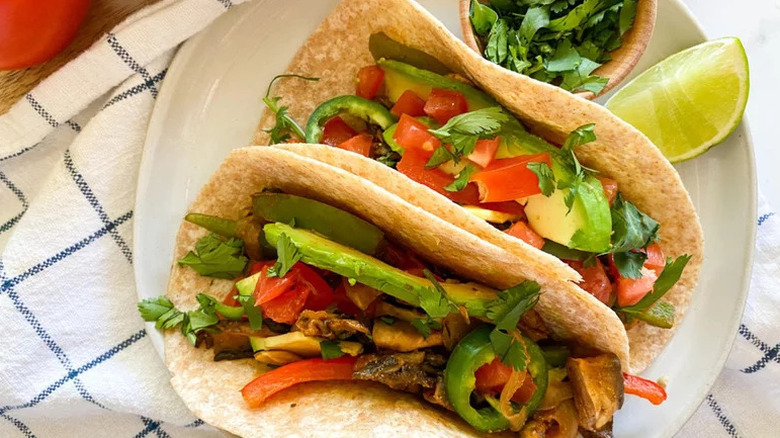 Portobello Fajitas in tortillas on white plate