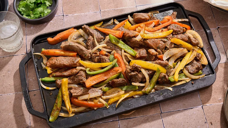 Ribeye Steak Fajitas on black griddle