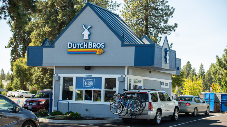Dutch Bros store with line of cars in drive-thru