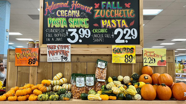 A selection of Fall items like pumpkins, squash, and flavored pasta on display at Trader Joe's