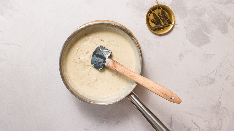 Sauce in pan beside fried sage