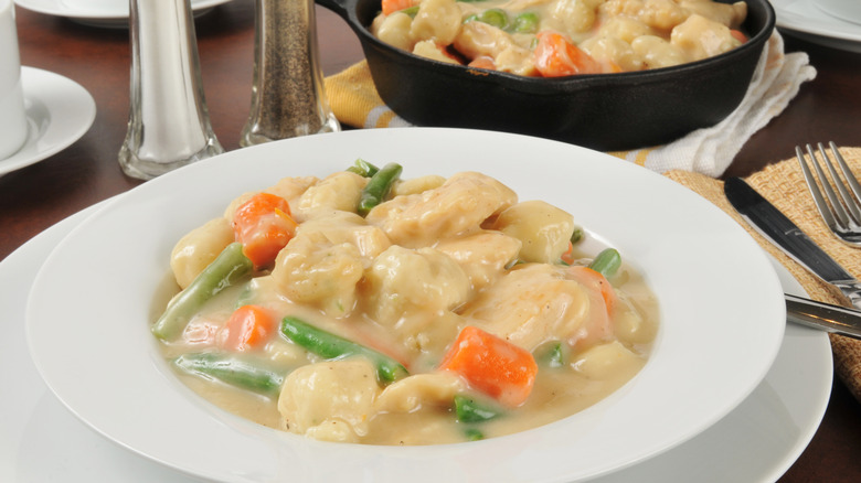 Chicken and dumplings in a bowl on a table