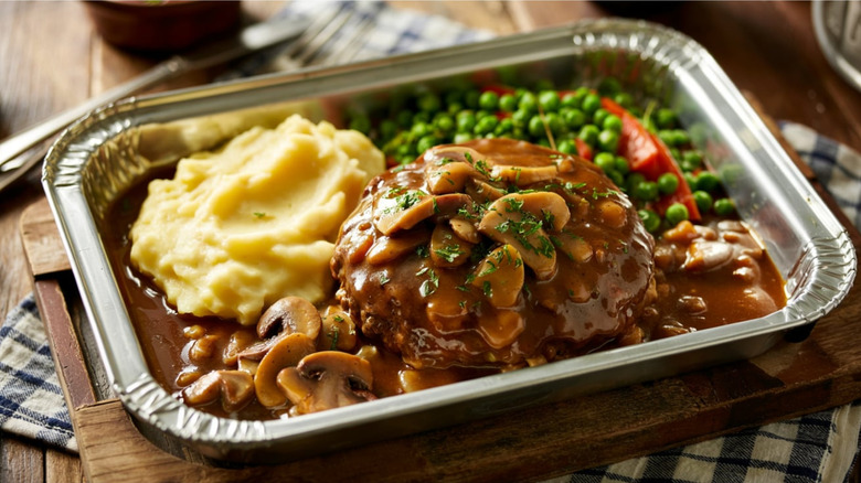 Salisbury steak TV dinner with mashed potatoes, peas, and carrots