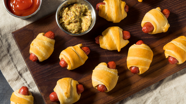 Aerial shot of pigs in a blanket atop a cutting board