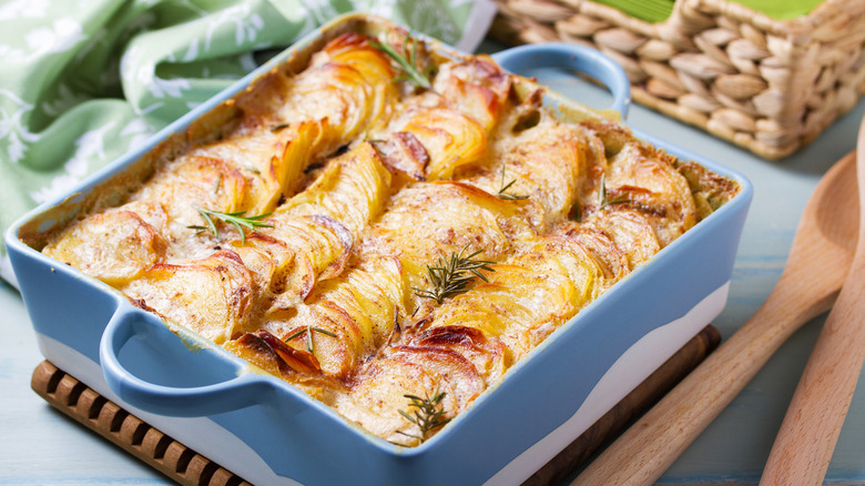 Scalloped potatoes in a baking pan on a table