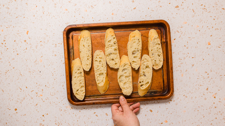 Baguette slices on baking sheet