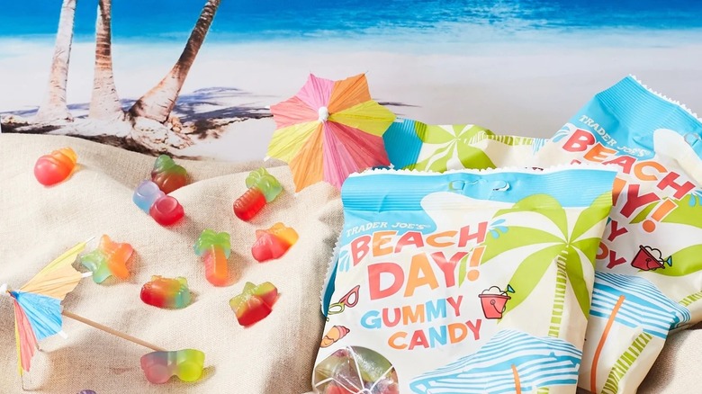 packages and pieces of of Trader Joe's Beach Day Gummy Candy on beach