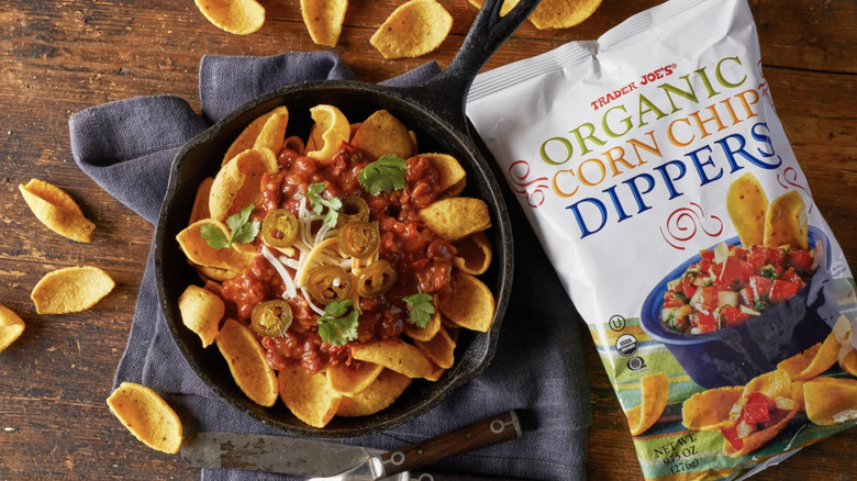 packages of Trader Joe's Organic Corn Chip Dippers next to nachos in cast iron pan