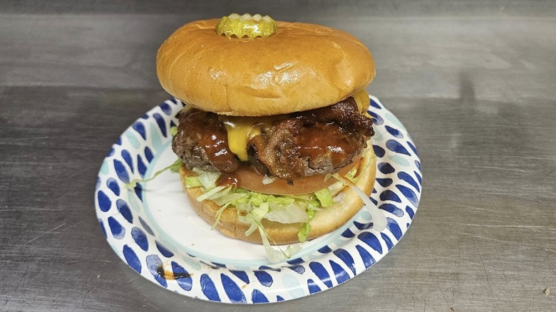 the western burger at Arctic Roadrunner sits on a paper plate