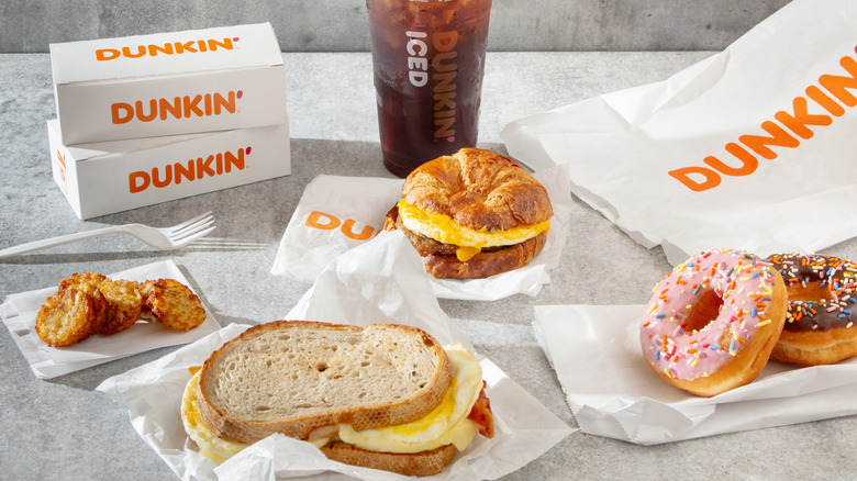 Breakfast items from Dunkin' including donuts, sandwiches, iced coffee, and hash browns