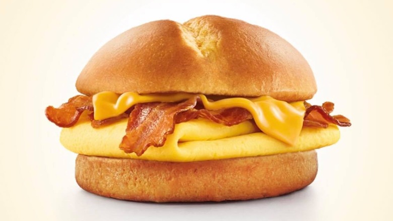 Brioche breakfast sandwich from Sonic restaurant on pale background