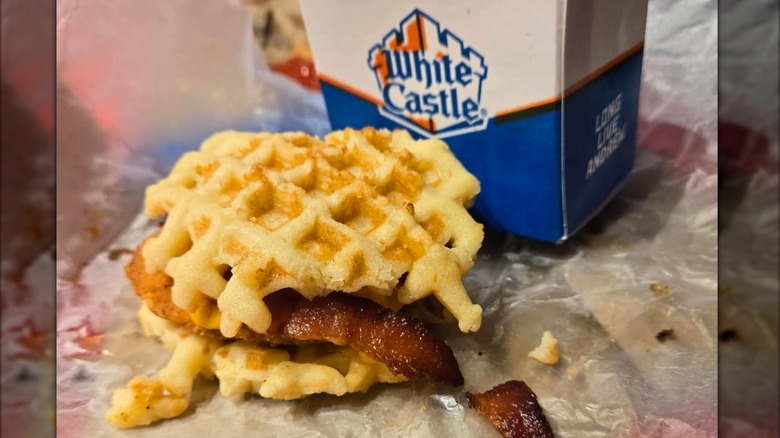 Waffle breakfast sandwich from White Castle next to box with restaurant logo