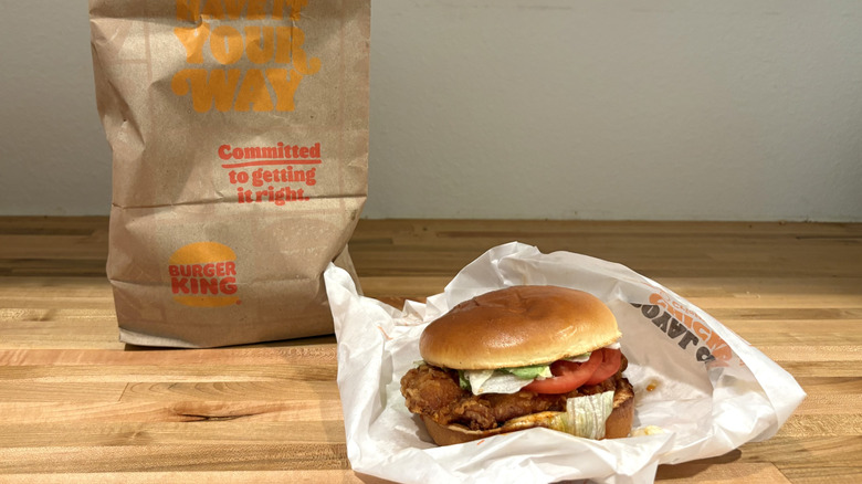 An unwrapped Burger King chicken sandwich with tomato and lettuce