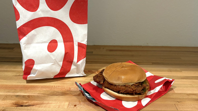 Chick-fil-A chicken sandwich with a golden bun on a red paper wrapper