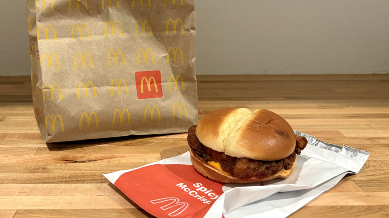 McDonald's chicken sandwich with sauce and its paper bag
