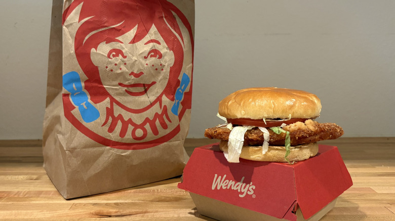 Wendy's chicken sandwich on top of a small box and next to the bag
