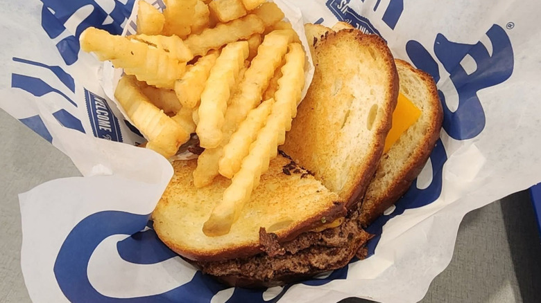 Culver's sourdough melt on branded paper, served with a bag of crinkle fries