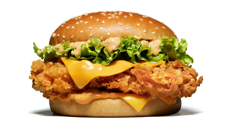 Crispy chicken burger with lettuce, cheese, and burger sauce