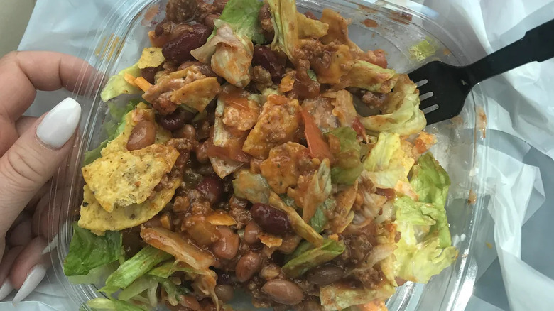 close up of hand holding open Wendy's Taco Salad