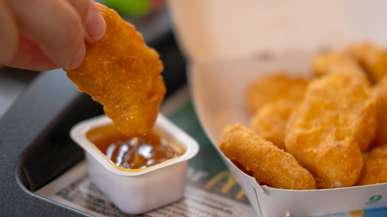 McDonald's nuggets dipping one in sauce