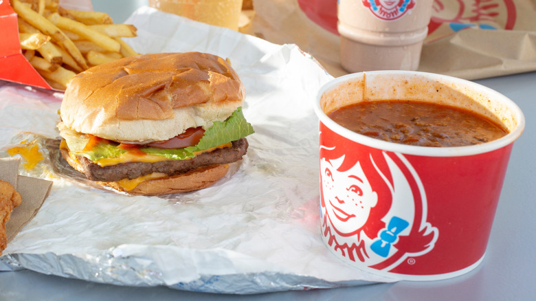 Cup of Wendy's chili beside burger