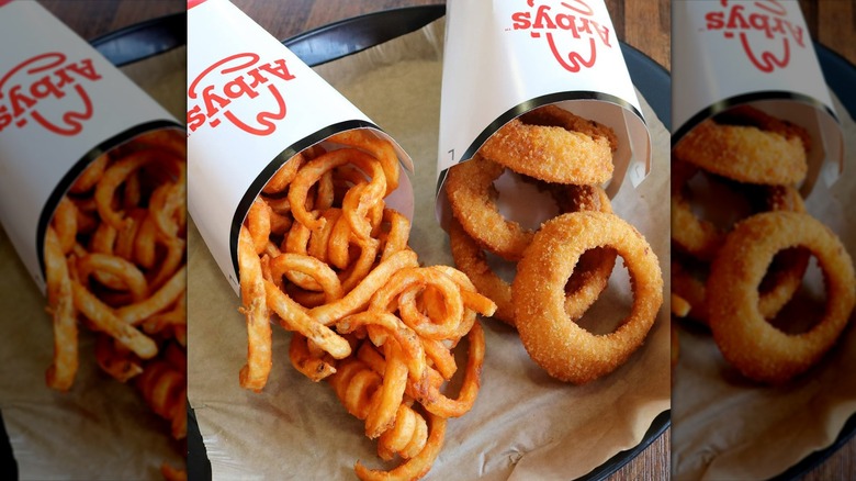 Arby's onion rings and curly fries in cardboard cartons