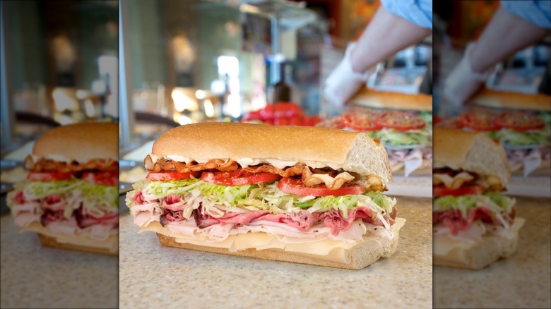 Sub sandwich with roast beef, turkey, cheese, shredded lettuce, and tomatoes