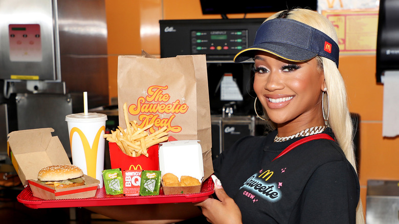 Saweetie holding a tray with her celebrity meal at McDonald's