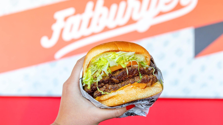 hand holding a Fatburger