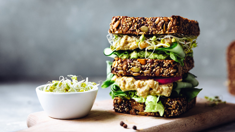 Stacked vegetarian sandwich with avocado and slaw