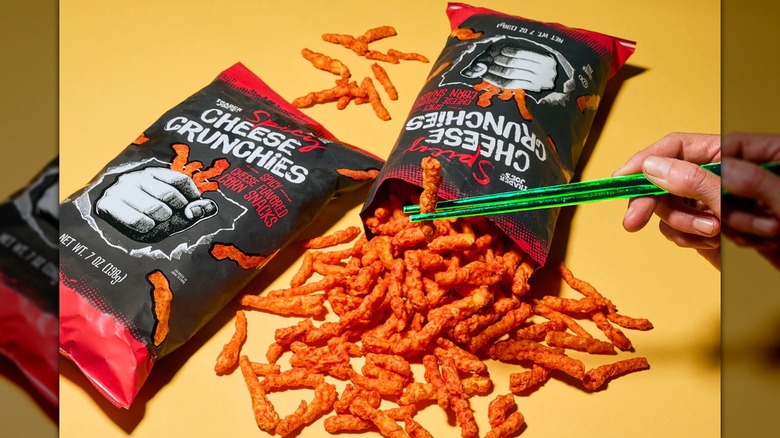 Two bags of Trader Joe's Spicy Cheese Crunchies with one bag open