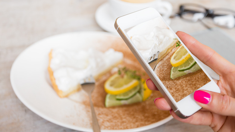 Person taking photo of food with phone
