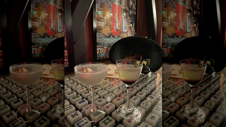 Two glasses of cocktail on a mahjong table inside The Felix in San Francisco