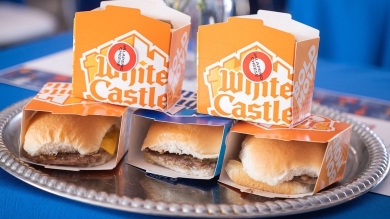 Five boxes of White Castle burgers stacked on a silver platter