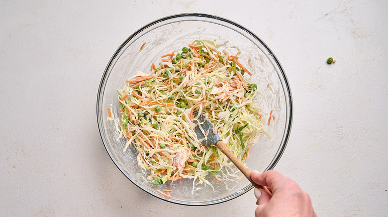 combining coleslaw ingredients in a bowl