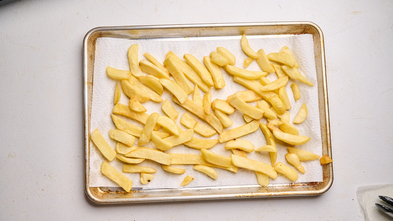 draining french fries on paper towels