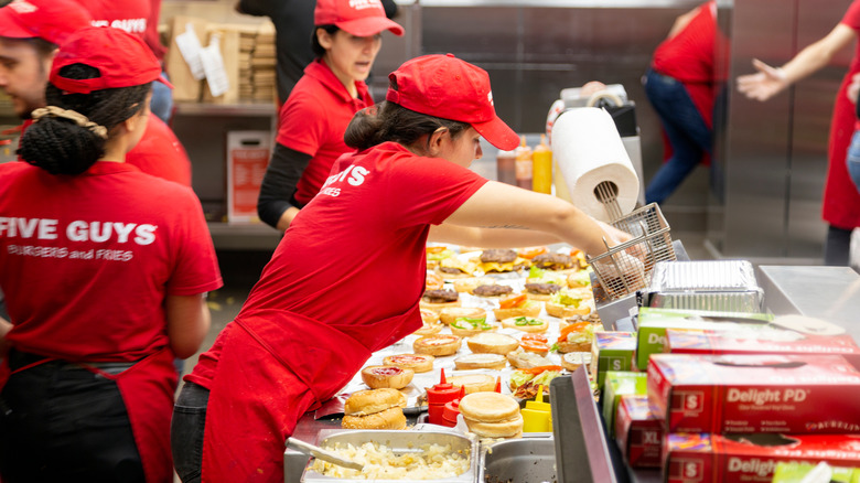 five guys workers cooking