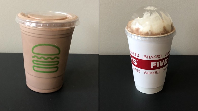 A split screen image of a Shake Shack plain chocolate milkshake on the left and a Five Guys plain chocolate milkshake with whipped cream and a domed plastic top on the right.