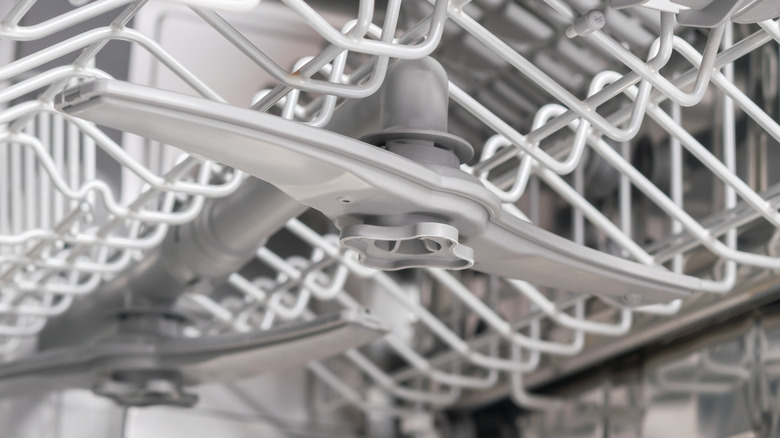 underneath view of spray arms in dishwasher