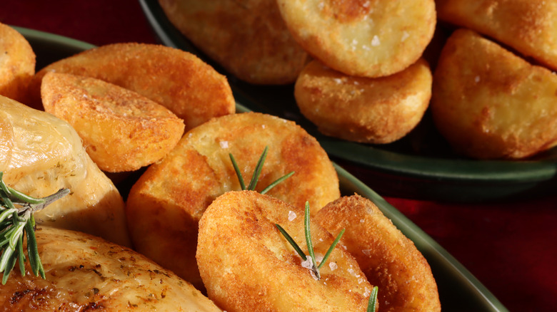 A close-up shot of crispy, browned, roasted potatoes