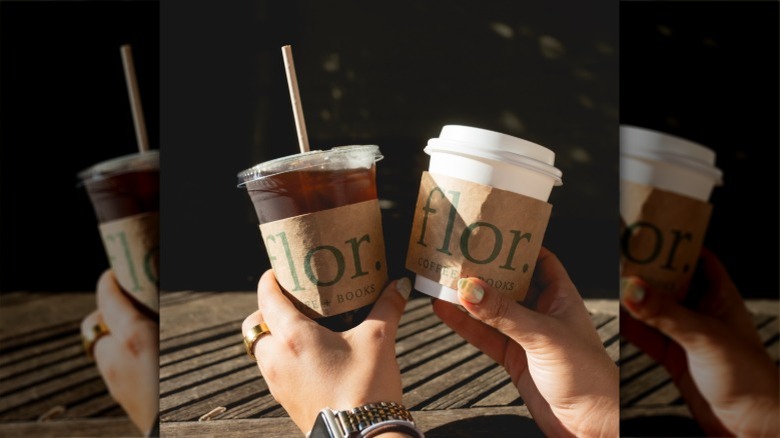 people holding up cups of iced coffee from Flor