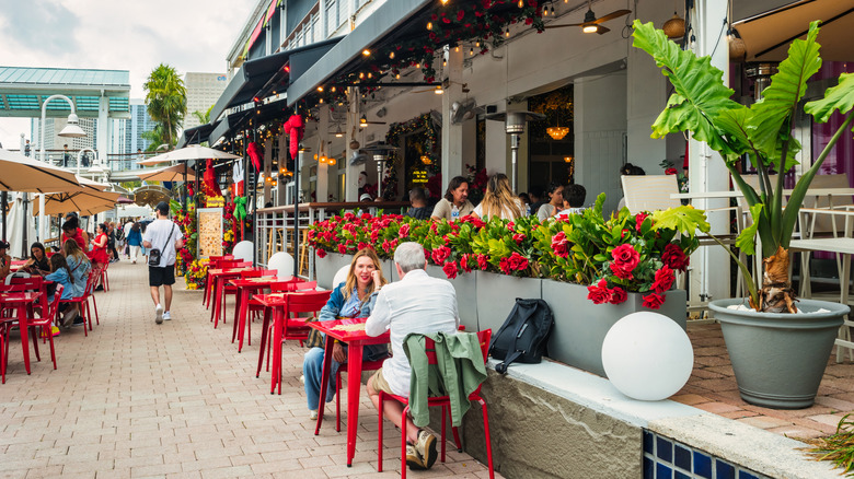 People dining outside in sunny area Miami