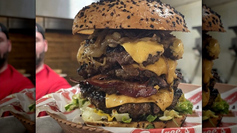 Behemoth cheeseburger with bacon and sauteed onions with seeded bun.