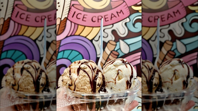Chocolate ice cream sundae against a colorful mural