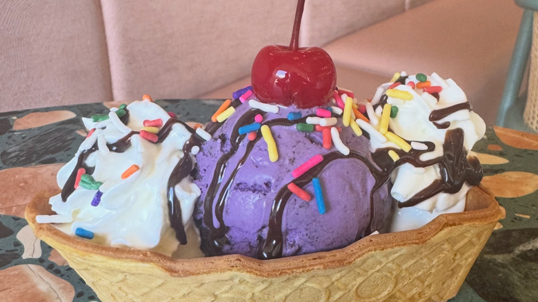 Ice cream sundae in a cone boat on a mosaic table