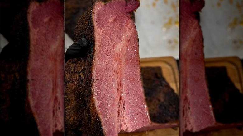 Smoked roast cut down the middle showing medium rare flesh.
