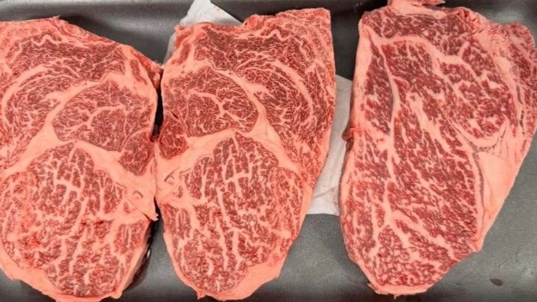 Three raw cuts of wagyu beef.