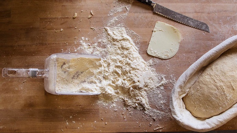 scoop of flour on wooden countertop 